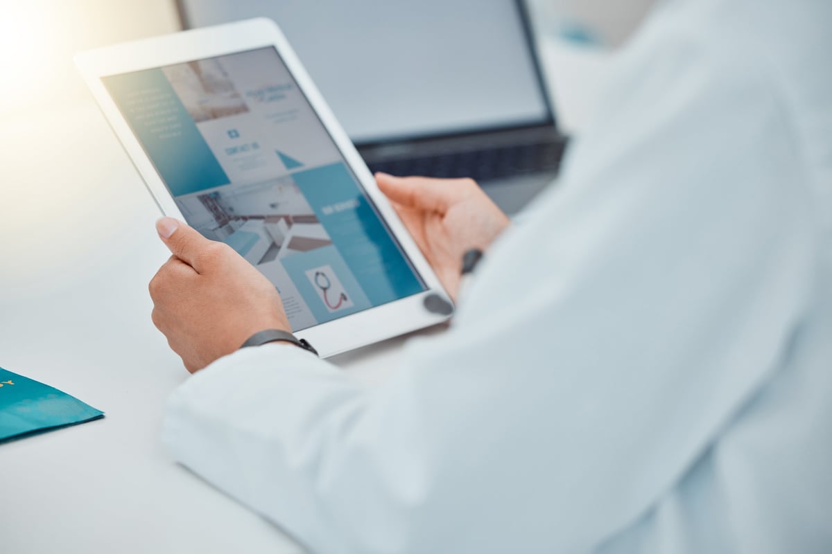 Doctor using digital tablet for healthcare website design